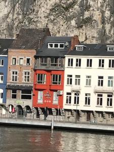 un grupo de edificios junto a una masa de agua en le coeur de ville, en Dinant