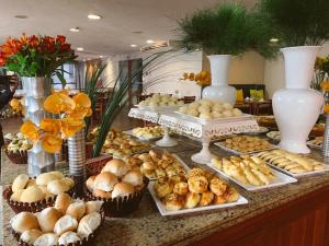 a buffet with many different types of bread and pastries at America Towers Hotel in Salvador