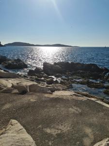 un cuerpo de agua con rocas en la orilla en Scents of nature-Dubrovnik area, en Mlini