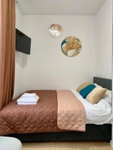 ein Schlafzimmer mit einem Bett und zwei Platten an der Wand in der Unterkunft MYFREEDOM Апартаменти метро Лук'янівська in Kiew