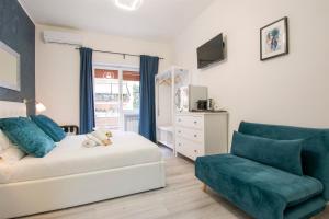 a bedroom with a bed and a couch and a chair at Luxury Boutique Hotel in Rome