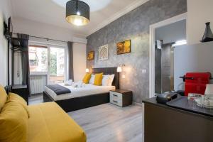 a bedroom with a bed with yellow pillows at Luxury Boutique Hotel in Rome