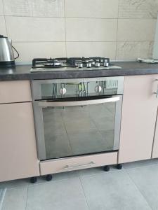 a kitchen with a stove top oven in a kitchen at Нова квартира за доступною ціною. in Luts'k