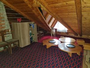 a room with two tables and a chair in a building at Sofra Kolonjare Agroturizem in Ersekë