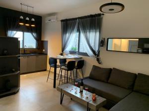 a living room with a couch and a table at Via Arad Apartments in Arad
