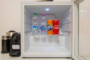 an open refrigerator filled with soda and sodas at Luxury Boutique Hotel in Rome