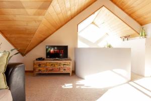 a living room with a tv and a window at Riverside Retreat in Queenstown