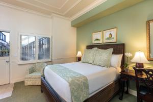 a bedroom with a bed and a desk and a chair at Tally Ho Inn in Carmel