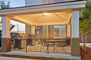 un patio coperto con tavolo e sedie di Candlewood Suites Portland Airport, an IHG Hotel a Portland