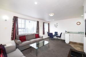 a living room with a couch and a table at Chevron Motel in Taupo