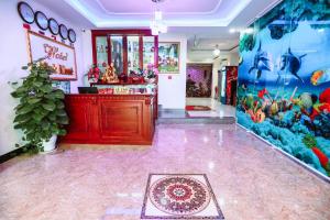 a restaurant with a fish mural on the wall at Minh Khue Hotel in Quy Nhon