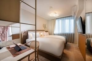 a hotel room with a bed and a desk with a laptop at Mantra Terrace Brisbane in Brisbane