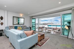 a living room with two couches and a large window at QV Spacious Waterfront 2 Bedroom Apartment - 791 in Auckland