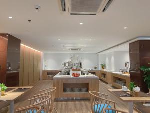a large kitchen with wooden tables and chairs at HẢI ÂU BIÊN CƯƠNG in Quy Nhon
