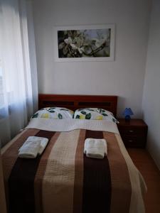 a bedroom with a bed with two towels on it at Apartament Reymonta przy morzu in Kołobrzeg