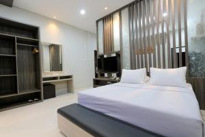 מיטה או מיטות בחדר ב-Sun In Pangandaran Hotel