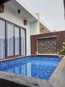 a swimming pool in the backyard of a house at Villa Ulin A3 at Villa Ubud Anyer in Serang