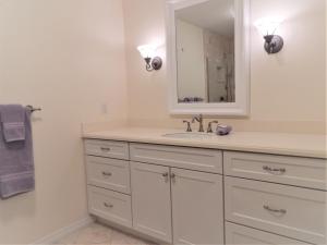 a bathroom with a sink and a mirror at Steps from the Gulf of Mexico II in Holmes Beach