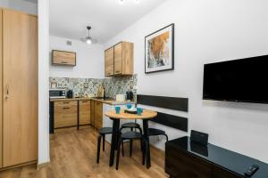 a small kitchen with a small table in a room at Sleepway Apartments - Modern Dream in Poznań
