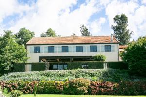 a house with a garden in front of it at Villa Vie in Tauranga