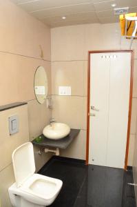 a bathroom with a toilet and a sink at DUDI HOTEL in Bikaner