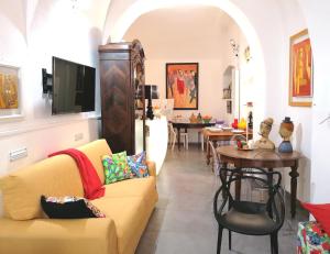 a living room with a couch and a table at La Foresteria Garden Boutique B&B in Catania
