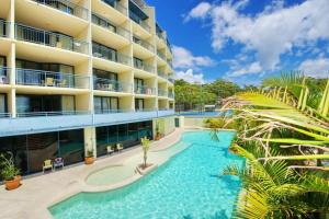 a hotel with a swimming pool in front of a building at Casablanca In Landmark Resort in Nelson Bay