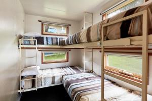 a small room with bunk beds and a window at Marengo Family Caravan Park in Marengo