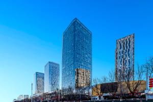 a group of tall buildings in a city at Happy Dragon Universal Vacation Hotel - close to Universal Studio and Wanda Plaza,free shuttle to the Resort,Free Coffee,Laundry in Beijing