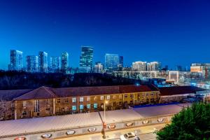 a building in front of a city at night at Happy Dragon Universal Vacation Hotel - close to Universal Studio and Wanda Plaza,free shuttle to the Resort,Free Coffee,Laundry in Beijing