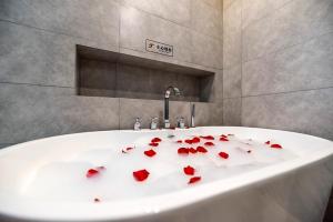 a bath tub with red hearts on it at Happy Dragon Universal Vacation Hotel - close to Universal Studio and Wanda Plaza,free shuttle to the Resort,Free Coffee,Laundry in Beijing
