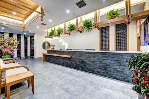 a lobby with plants on the wall at Happy Dragon Universal Vacation Hotel - close to Universal Studio and Wanda Plaza,free shuttle to the Resort,Free Coffee,Laundry in Beijing