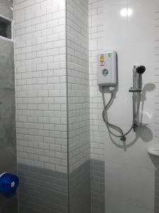 a shower stall with a soap dispenser in a bathroom at ไนท์ ฟอร์ ยู เรสซิเดนซ์ in Buriram