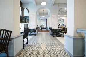 a dining room with chairs and a table at The Krungkasem Srikrung Hotel in Bangkok