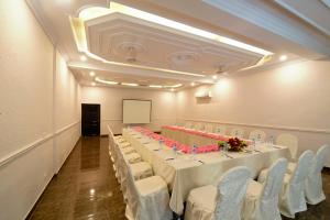 a conference room with a long table and chairs at Hotel One Lalazar Multan in Multan