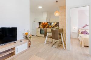a living room with a kitchen and a dining room at Apartments Niro in Split