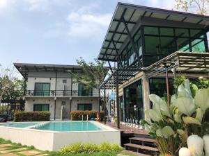a building with a swimming pool in front of it at ชิดชายชล รีสอร์ท น่าน in Nan