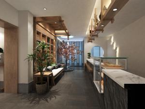 a lobby with a couch and plants in a room at Happy Dragon Universal Vacation Hotel - close to Universal Studio and Wanda Plaza,free shuttle to the Resort,Free Coffee,Laundry in Beijing