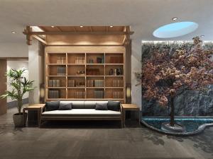 a living room with a couch and a book shelf at Happy Dragon Universal Vacation Hotel - close to Universal Studio and Wanda Plaza,free shuttle to the Resort,Free Coffee,Laundry in Beijing