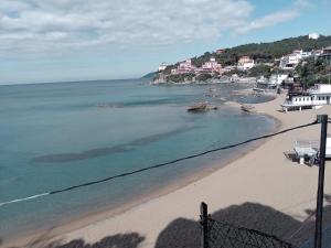 a view of a beach with houses and the ocean at Caletta Beach in Castiglioncello