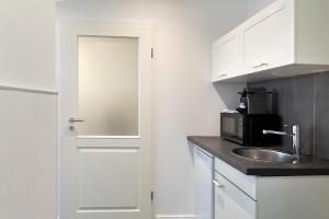 Kuchyň nebo kuchyňský kout v ubytování Luxx City Apartments