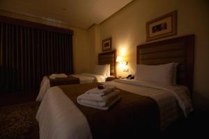Hotel One Tariq Road Multan客房内的一张或多张床位