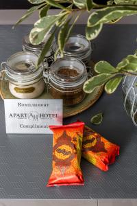 a table with jars of honey and a napkin at Apart-Hotel on Pushkina 26 in Kazan