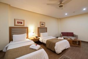 Hotel One Tariq Road Multan客房内的一张或多张床位