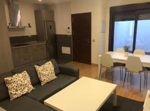 a living room with a couch and a table and a kitchen at Gav Remedios 20 in Ronda +21 photos