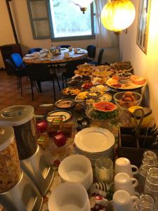 a table filled with plates and bowls of food at CA' LA SOMARA in San Pantaleo