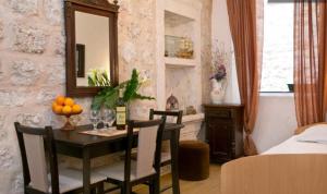 a dining room with a table and a mirror at Old Town Budget in Dubrovnik