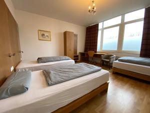 a hotel room with two beds and a table at Big Space-Loft in Hannover