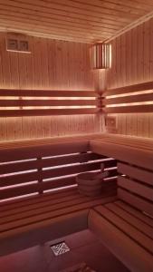 a sauna with a bench and a light on it at Agroturystyka Podzamcze in Krzeszowice