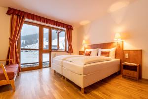 Postel nebo postele na pokoji v ubytování Club Hotel am Kreischberg